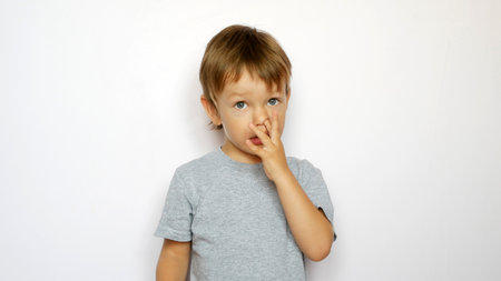 A cute boy picking his noseの写真素材