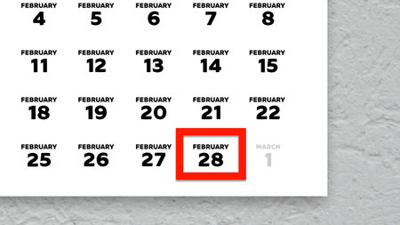 Close-up of the date February 28th marked with a red cursor on the wall calendar 2026