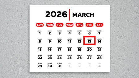 The date March 13th marked with a red cursor on the wall calendar 2026