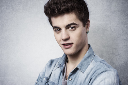 Cool confident guy smirking and looking at camera