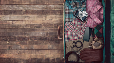 Hipster traveler vintage ready suitcase with camera and clothing, blank copy space, top viewの写真素材