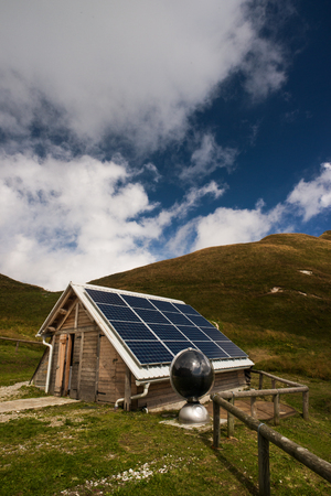 Solar panels on a mountain hut, electrical energy production and environmental conservation conceptの写真素材
