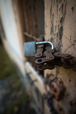 A oldest Door closed with oldest padlock and steel chainの写真素材
