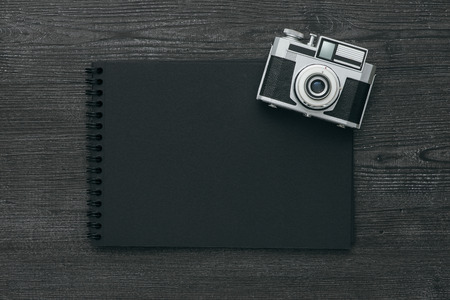 Blank dark photo album and vintage camera, photography and memories conceptの写真素材