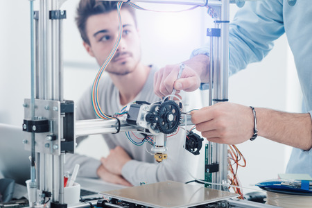 Young students researchers using an innovative 3D printer in the laboratory, engineering and prototyping conceptの写真素材