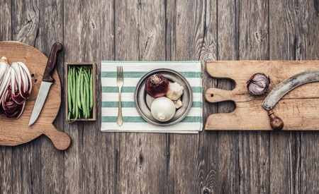 Fresh vegetables, chopping boards and utensils on a vintage kitchen worktop, healthy eating and cooking conceptの写真素材