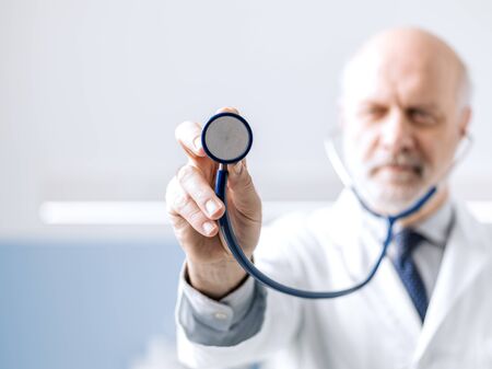 Professional doctor showing a stethoscope before a medical checkup, medicine and healthcare conceptの写真素材
