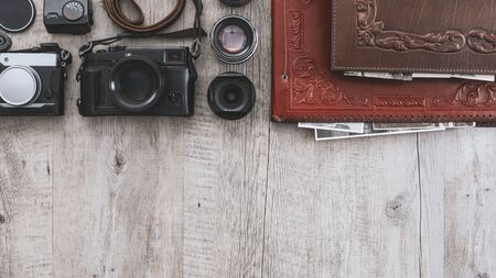 Hipster photographer equipment on a vintage wooden desktop with copy space, flat layの写真素材