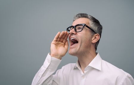 Confident man shouting out loud, advertising and communication concept