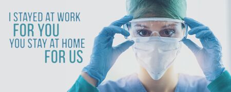 Female doctor wearing protective medical equipment and coronavirus covid-19 awareness message, I stayed at home for you, you stay at home for usの写真素材