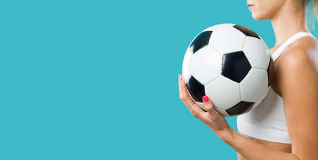 Sporty girl holding a soccer ball, women and sports conceptの写真素材