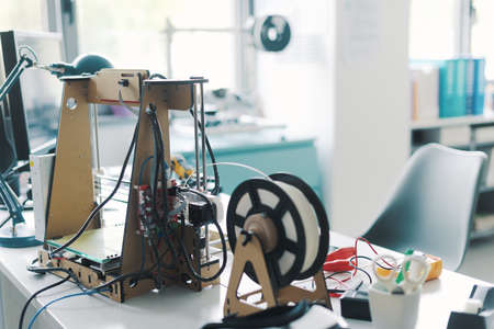 3D printer and tools on the laboratory desk: additive manufacturing, prototyping and engineering conceptの写真素材