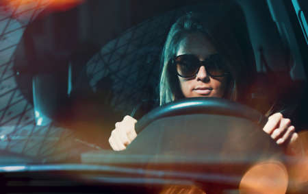 Young attractive woman with sunglasses driving her car.の写真素材