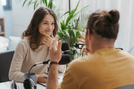 Young professional speaker conducting a live podcast interview, communication and media conceptの写真素材