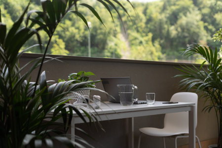 Balcony with table, chair and lush plants