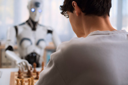 A futuristic chess match between boy and robot takes place.