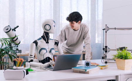 A Boy studies with the help of a Robot. The result is fruitful. Robot and Human Collaboration Concept.の写真素材