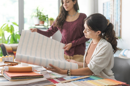 Professional interior designers and decorators checking different types of wallpaper, home renovation and creativity conceptの写真素材