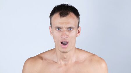 Portrait of handsome, surprised, shocked, stunned  young manの写真素材