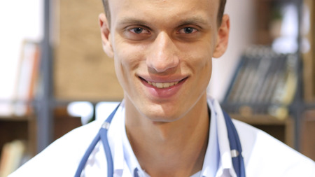 Portrait of friendly male doctor smiling in Clinicの写真素材