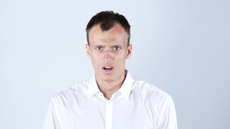 Young man surprised , shocked after crisisの写真素材
