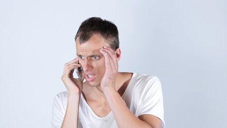 Man speaking on his cell phone ,jobless  sad, rejection of his workの写真素材
