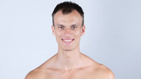 Smiling , portrait of a handsome young shirtless manの写真素材