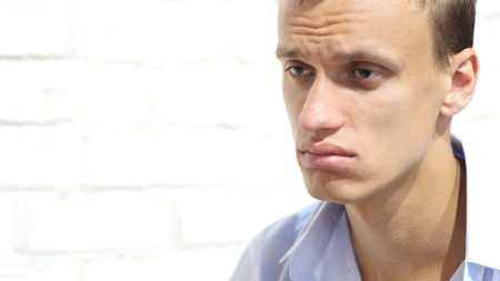 Sad desperate business man crying for financial crisisの写真素材