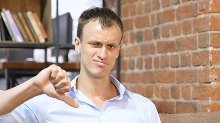 disapproval gesture with finger: no sign, denial, loose, thumbs downの写真素材