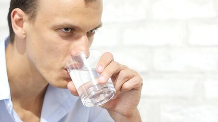 Handsome businessman in casual cloth  drinking water in officeの写真素材