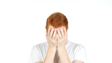 Depressed Man with Problems holding hand over his Face