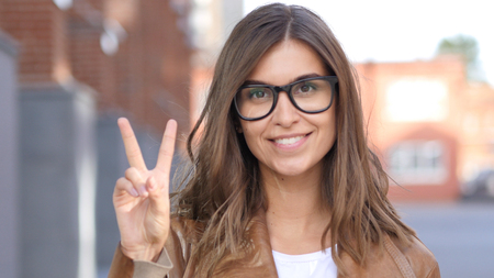 Victory Sign by Successful Female Designer, Portrait Outside Loft Officeの写真素材