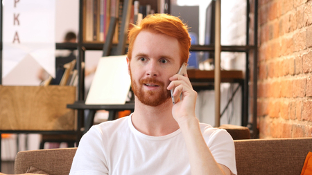 Talking on Phone in Office, Red Hair Designer, Loft officeの写真素材