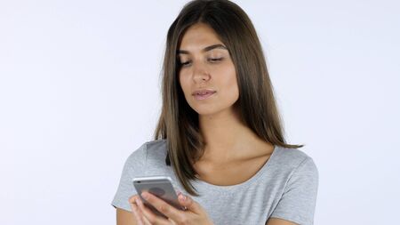 Using Smartphone Beautiful Girl, White Background in Studioの写真素材