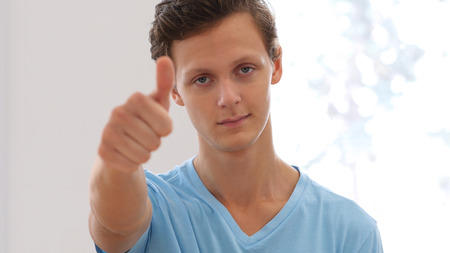 Thumbs Up by Smiling Young Designer, Portrait of Studentの写真素材