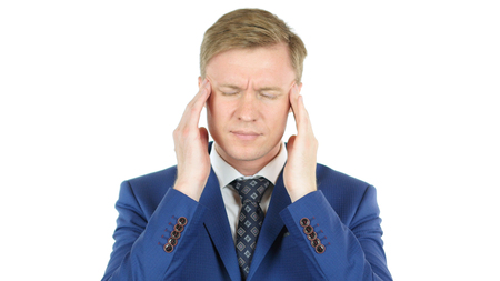 Young businessman suffering from headache touching temples over white backgroundの写真素材
