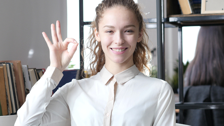Beautiful Brunette Woman Showing Ok Sign, Indoorの写真素材