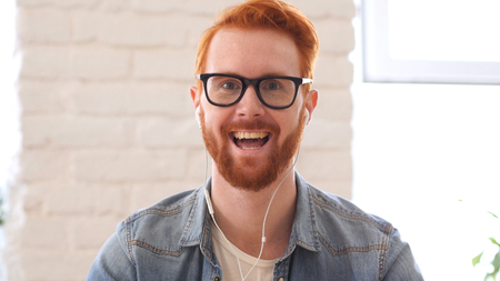 Taking Online, Video Chat, Skype by Man with Beard and Red Hairsの写真素材