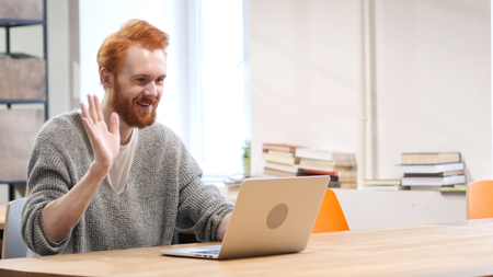 Online Video Chat on Laptop at Work, Man with Red Hairs and Beardの写真素材