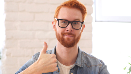 Reaction of Success, Thumbs Up, Appreciating Man with Beard and Red Hairsの写真素材