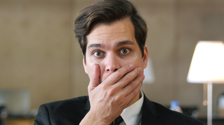 Shocked Businessman in Office, Sudden Unbelievable Lossの写真素材