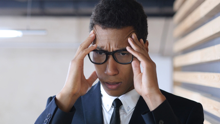 Desperate Tired Afro-American Businessman with Headacheの写真素材