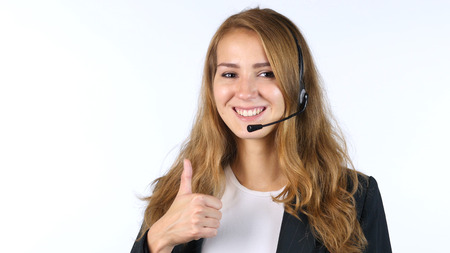 Portrait Of Call Center Girl Showing Thumbs Up , White backgroundの写真素材