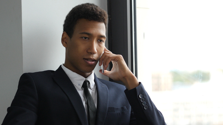 Businessman in Suit Talking on Phone, Busy Negotiatingの写真素材