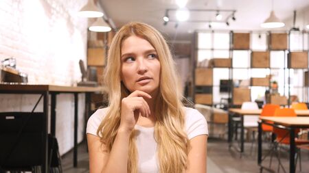 Young Girl Thinking in Officeの写真素材