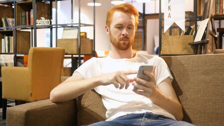 Young man using smartphone , designerの写真素材