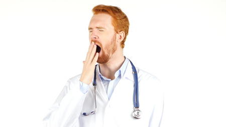 doctor sleeping , tired , yawning  on white backgroundの写真素材