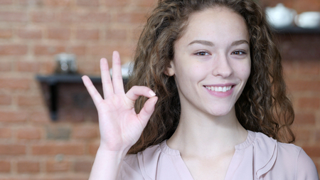Woman Showing Ok Sign, Indoorの写真素材