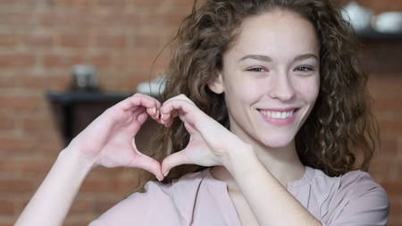 Handmade Heart Sign by Young Woman, Indoorの写真素材