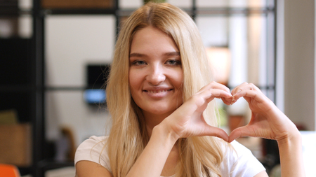 Blonde Girl Showing Heart , made by handsの写真素材